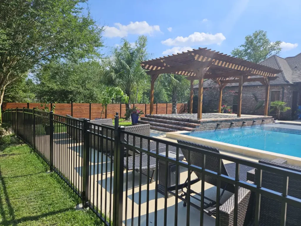 iron fence with pergola next to swimming pool in livingston louisiana